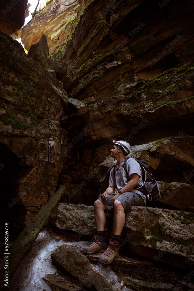 Mixed race male exploring the Ellenville Fault Line Ice Caves in Ellenville, New York. Mixed race male exploring the Ellenville Fault Line Ice Caves in Ellenville, New York.