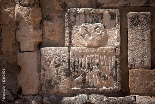 A stone relief with the image of a Guacamaya decorates a temple in the Mayan city of Uxmal, Yucatan Peninsula, Mexico photo
