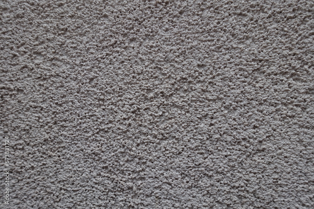 Close view of dusty wall with coarse light gray roughcast finish Close view of dusty wall with coarse light gray roughcast finish
