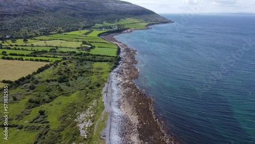 West of Ireland, the deep blue sea meets the green land on the edge of the Burren photo