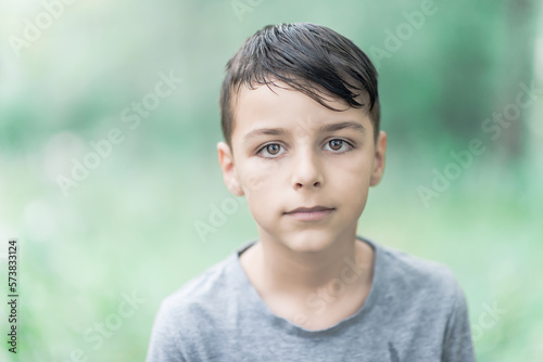 child standing outside and posing, a portrait of a boy