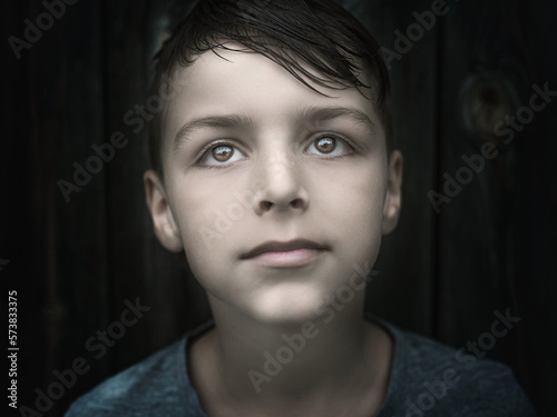 child standing outside and posing, a portrait of a boy