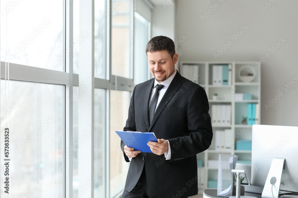 Fototapeta premium Male accountant with document in office
