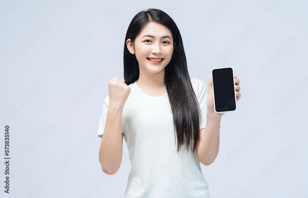 Young Asian girl using smartphone on background Young Asian girl using smartphone on background