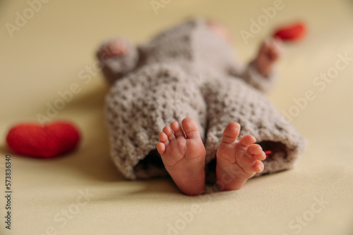 Legs of a newborn. Baby feet. The tiny foot of a newborn in soft selective focus. High quality photo