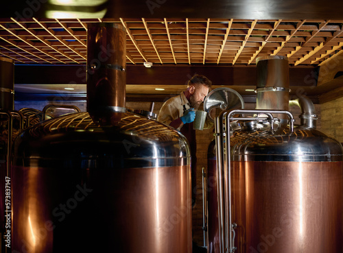 Fotografía Copper boil kettle and distillery tanks in craft beer brewery