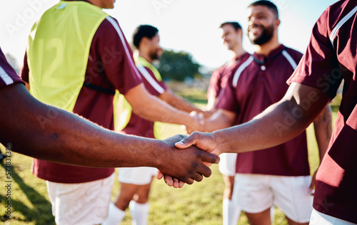 Men, sports and handshake for greeting, introduction or sportsmanship on the grass field outdoors. Sport team shaking hands before match or game for competition, training or workout exercise together