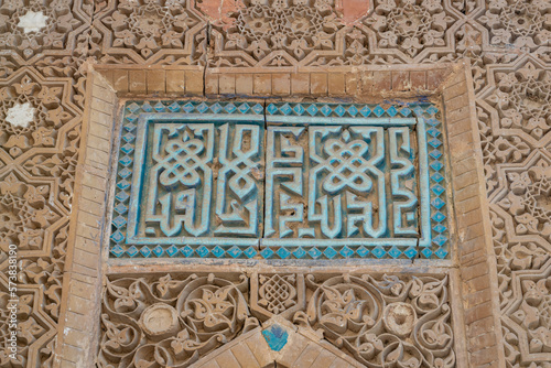 Detail view of beautiful ancient terracotta and turquoise blue ceramic decor on exterior wall of historic Mazar-i-Sharif islamic shrine near Panjakent or Penjikent, Sughd, Tajikistan