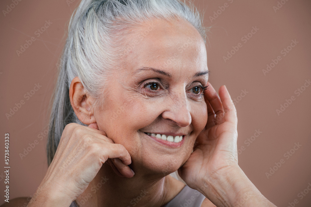 Portrait of smiling senior woman in studio. Portrait of smiling senior woman in studio.