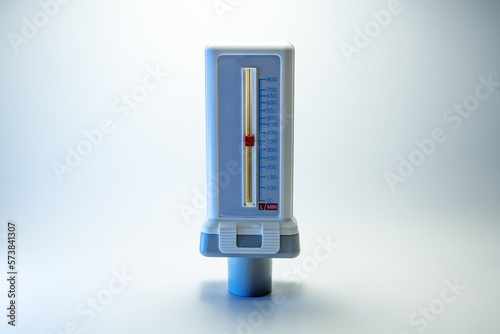 Peak flow meter, medical device that measures the maximum rate of exhalation of a person to monitor lung function and breathing. Light background, copy space, selected focus photo