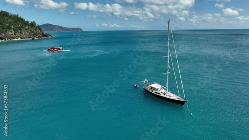 small sail yacht at a tropical island near coral reef in queensland australia photo