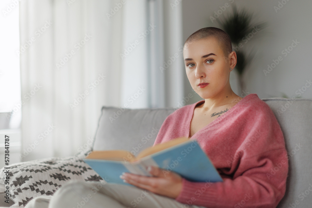 Young woman with cancer reading book, cancer awareness concept. Young woman with cancer reading book, cancer awareness concept.