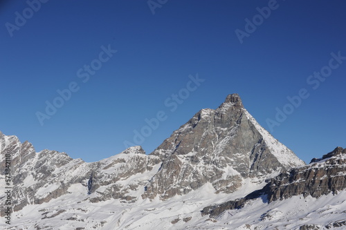 Matterhorn mountain peak in Alps in winter with snow and clear blue sky in Cervinia, Italy and Zermatt, Switzerland. Beautiful and magnificent landscape on a sunny day