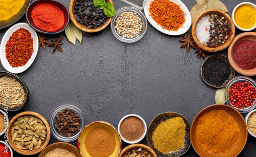 Various spices in bowls on stone table