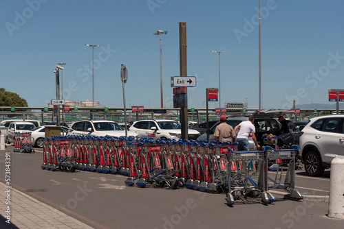 Cape Town South Africa. 2023. Line up of luggage trolley's in a renatl car parking area.