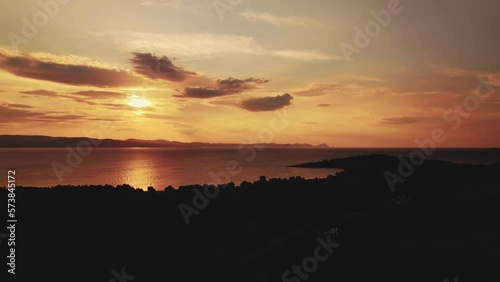 Idyllic beach sunrise in Kassandra, Greece with a dramatic cloudy sky at golden hour. High-quality 4k footage photo