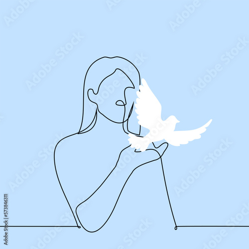 woman stands with outstretched hand with which a white dove takes off - one line drawing vector. concept symbol of peace, truce, end of war
