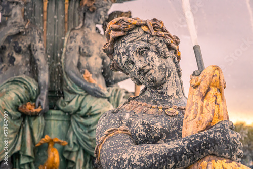 Close up on a naiad of a water fountain on the Place de la Concorde square in Paris, France at sunset photo