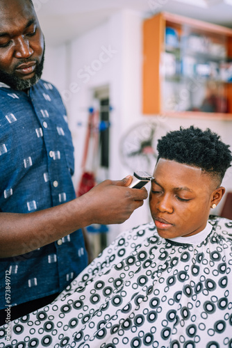 A young queer masculine woman getting a haircut