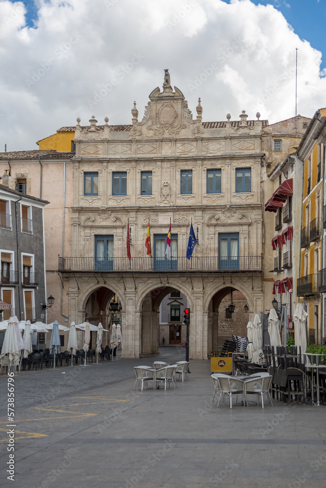 View at the Cuenca City Hall, a Rococo building with big arches located on Plaza Mayor , Cuenca downtown, typical traditional colored architecture buildings around