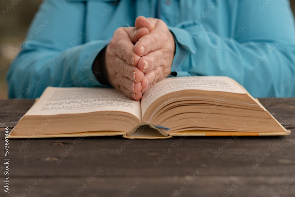 woman with her hands on top of a holy book woman with her hands on top of a holy book