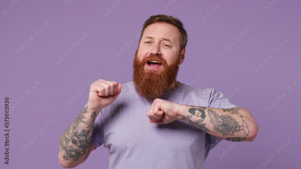 Fancy vivid happy fun bright young man 30s wear casual clothes dance waving rising have fun enjoy relax celebrate play fluttering hair isolated on plain pastel light purple background studio portrait