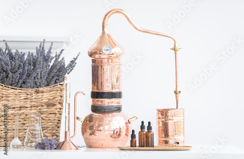 Distillation of lavender essential oil. Copper alambic in a Scandinavian interior. Chemical laboratory
