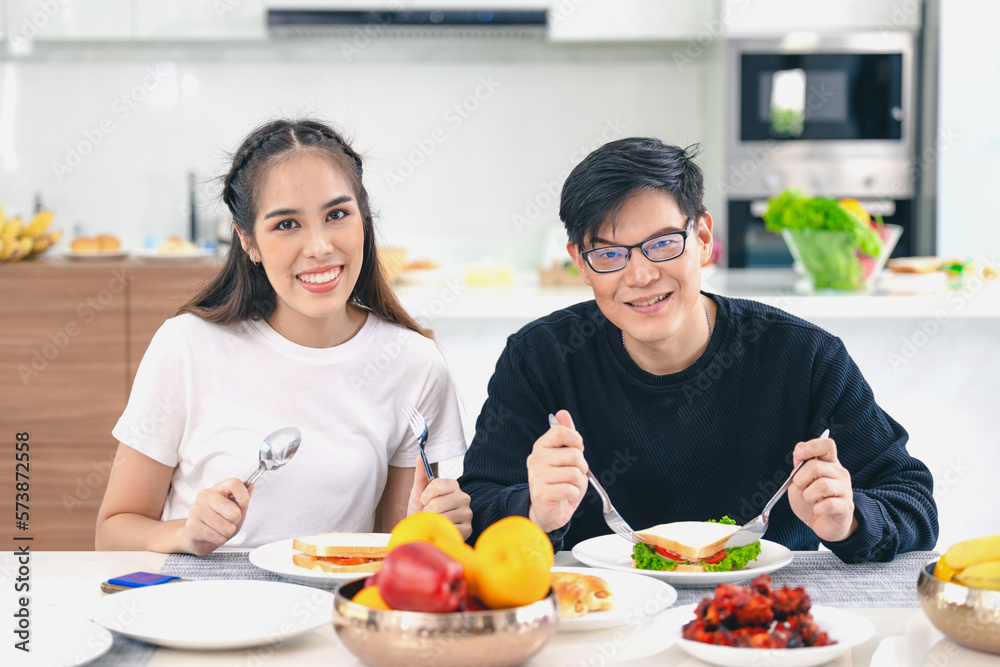 Portrait couple Asian man and woman enjoy eating healthy food. healthcare home family people.