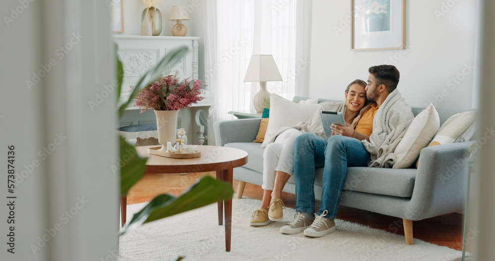 Couple, happy or tablet for communication, networking or social media app at home. Movie, video or love man and woman relax in living room streaming online, internet or website with smile in house Couple, happy or tablet for communication, networking or social media app at home. Movie, video or love man and woman relax in living room streaming online, internet or website with smile in house