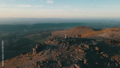 Aerial Drone footage of the majestic Galtymore Mountain Range in Ireland. Soaring above rugged terrain, winding trails, and stunning greenery for awe-inspiring views. Perfect for adventure travelers. photo