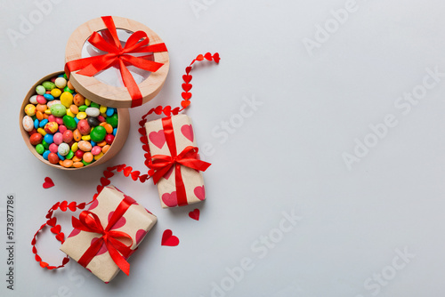 Valentine day composition  sweet candy  with gift boxes with bow and red felt hearts  photo template  background. Top View with copy space
