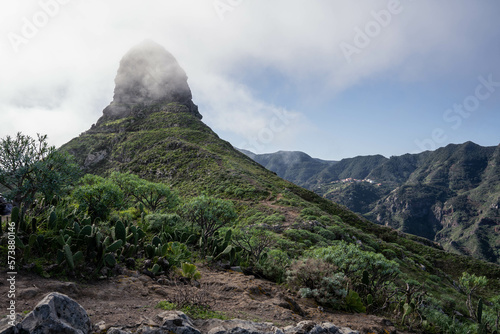 View of the Taborno mountain in National Park Anaga, Tenerife, Canary Islands, Spain. Roque de Taborno. Top of the Taborno mountain in clouds.  photo