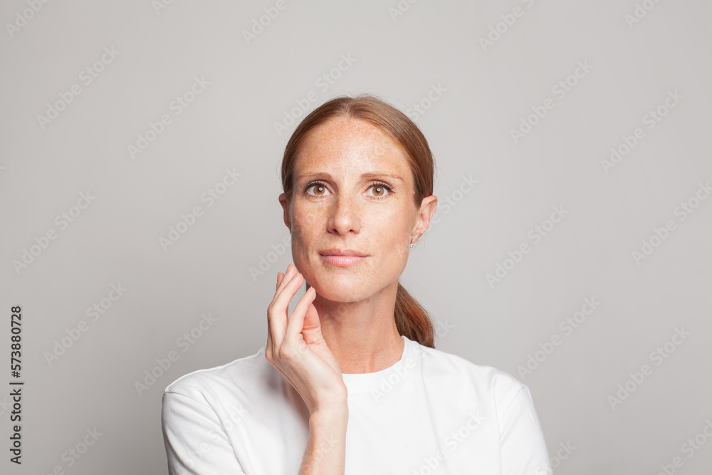 Female face. Cute mid adult woman with clean fresh healthy skin with freckles on white background Female face. Cute mid adult woman with clean fresh healthy skin with freckles on white background