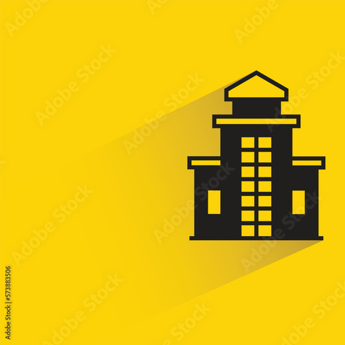 building with shadow on yellow background