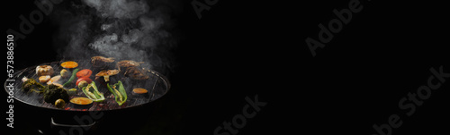 Green grilling. Various vegetables - artichokes, peppers, eggplants are grilled. Proper, vegan nutrition. Dark background. Banner. Place for text. photo