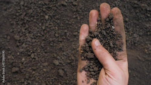 Fertile soil preparation field agriculture concept. Handful of dirt hand holding soil hand field agriculture farmer hand full of soil organic earth ground. Farming. Fertile ground. Closeup. Copy space