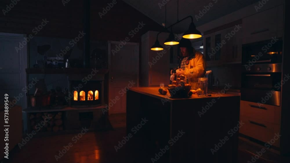 Person Standing In A Small Kitchen Of A Cottage With A Fireplace. Medium Shot