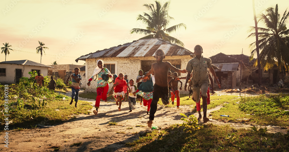 Group of African Little Children Running Towards the Camera and Laughing in Rural Village. Black Kids Full of Life and Joy Enjoying their Childhood and Playing Together. Little Faces with Big Smiles - obrazy, fototapety, plakaty 