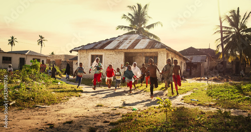 Group of African Little Children Running Towards the Camera and Laughing in Rural Village. Black Kids Full of Life and Joy Enjoying their Childhood and Playing Together. Little Faces with Big Smiles