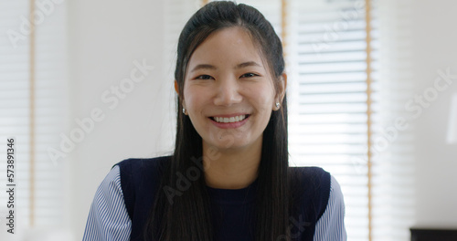 Asia people young casual woman sit smile work at table desk home workspace self learn on laptop in modern workforce reskill career upskill job data analyst MBA lesson. Happy face girl look at camera.
