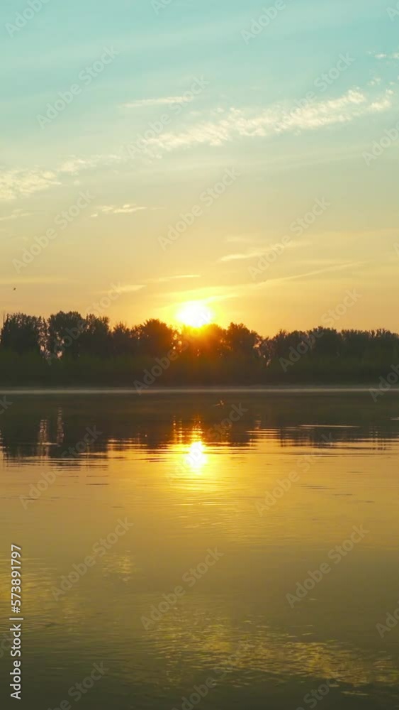 Landscape with sunrise over big river. Vertical video Landscape with sunrise over big river. Vertical video