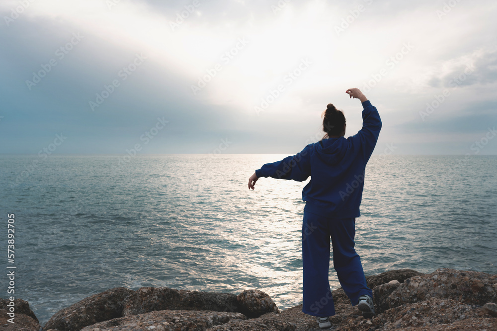 Beautiful young woman outdoors at sea enjoying freedom. Wanderlust concept. Beautiful young woman outdoors at sea enjoying freedom. Wanderlust concept.