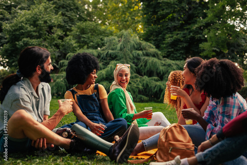 Friends on day time party in park