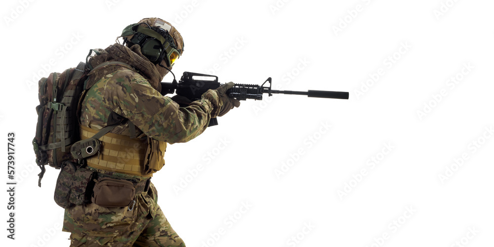 Mercenary soldier with an automatic rifle in his hand aiming in enemy.
