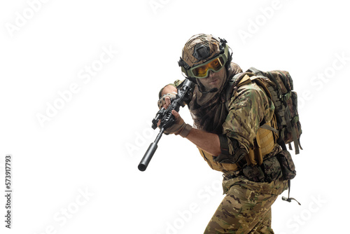 A mercenary soldier with AK-74 in his hand and aiming in enemy. photo