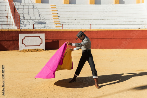 Male matador waving bright cape photo
