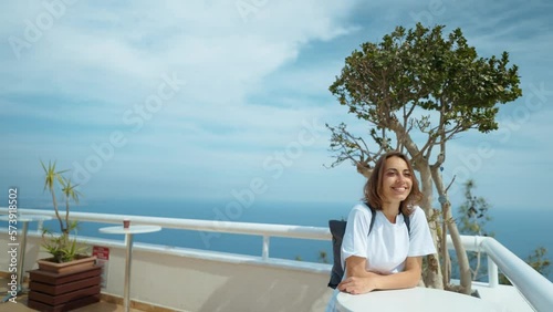 Wallpaper Mural Tourist traveler standing on viewing platform agaist blue background valley landscape view mockup for text. hipster young girl in casual clothes enjoying a view from mountain to sea and Antalya city Torontodigital.ca