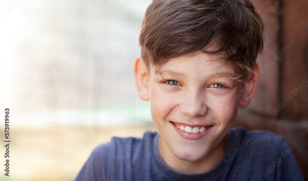 the boy is naturally and liberally smiling at the camera the boy is naturally and liberally smiling at the camera