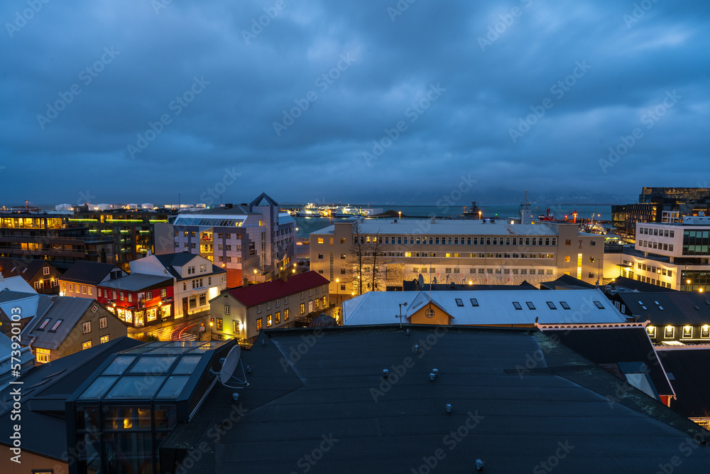 A night time photograph of Rykjavik, Iceland including the harbor