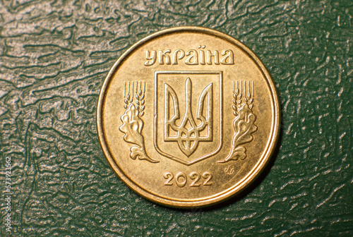 Coin reverse 10 kopecks Ukrainian close-up on a dark background.